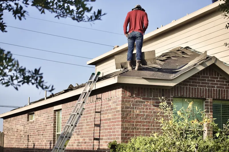 Professional roofer working on a residential roof in Aurora